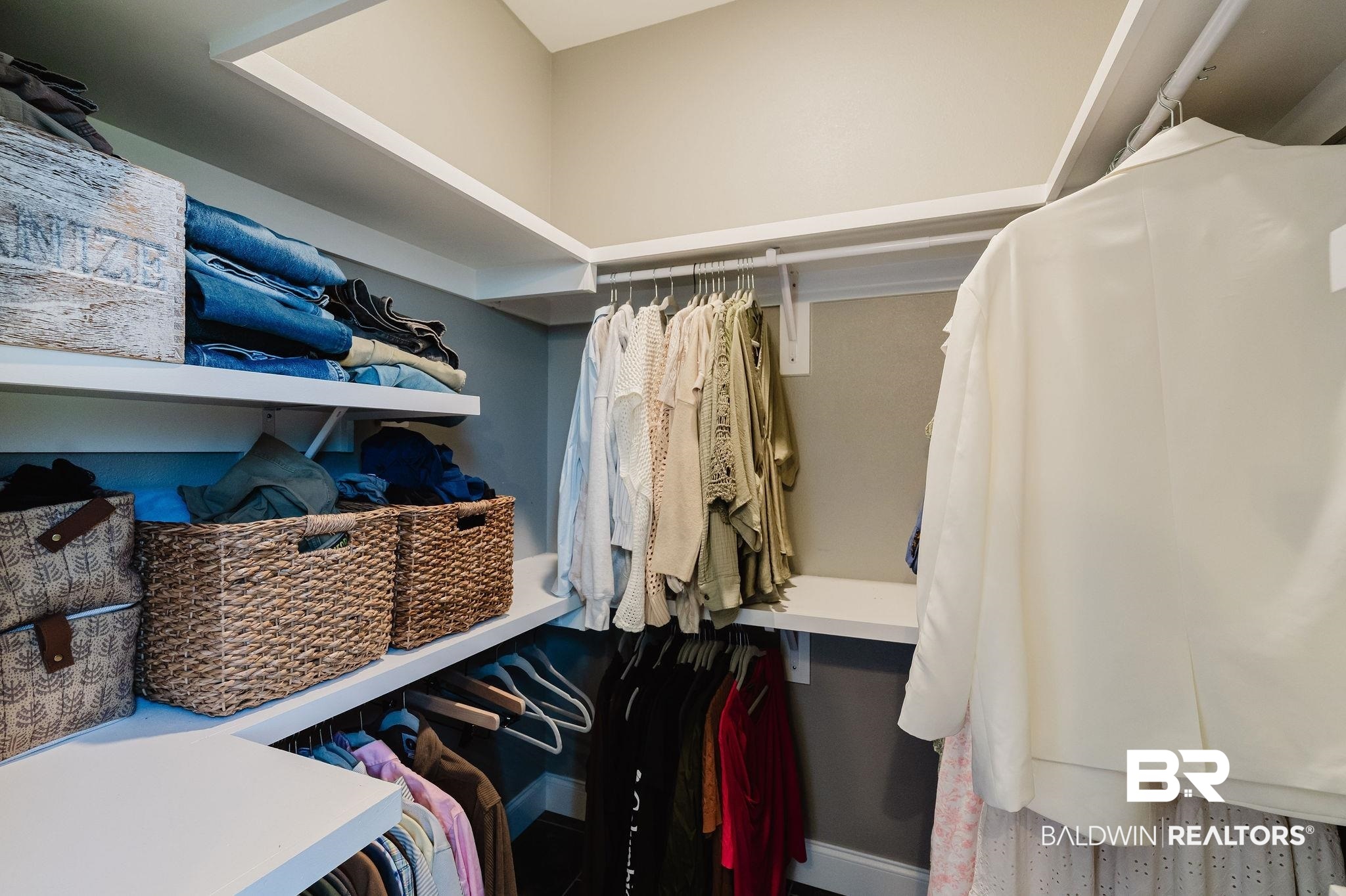 7872 Calverton Street Foley, AL 36535 - Photo 24 of 76 Custom closet system featuring white shelving, multiple hanging rods, and light gray wall paint