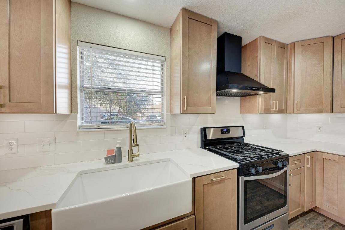 2317 Friarcreek Loop Round Rock, TX 78664 - Photo 11 of 36 a kitchen with a sink a stove and cabinets