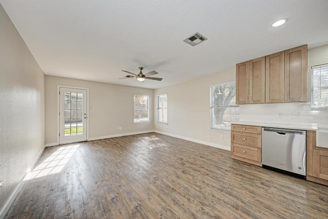 2317 Friarcreek Loop Round Rock, TX 78664 - Photo 13 of 36 a kitchen with granite countertop wooden floors and white cabinets