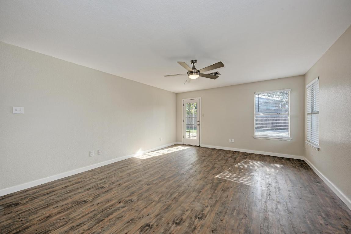 2317 Friarcreek Loop Round Rock, TX 78664 - Photo 14 of 36 wooden floor in an empty room with a window