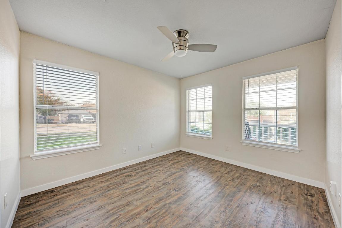 2317 Friarcreek Loop Round Rock, TX 78664 - Photo 17 of 36 a view of an empty room with wooden floor and a window