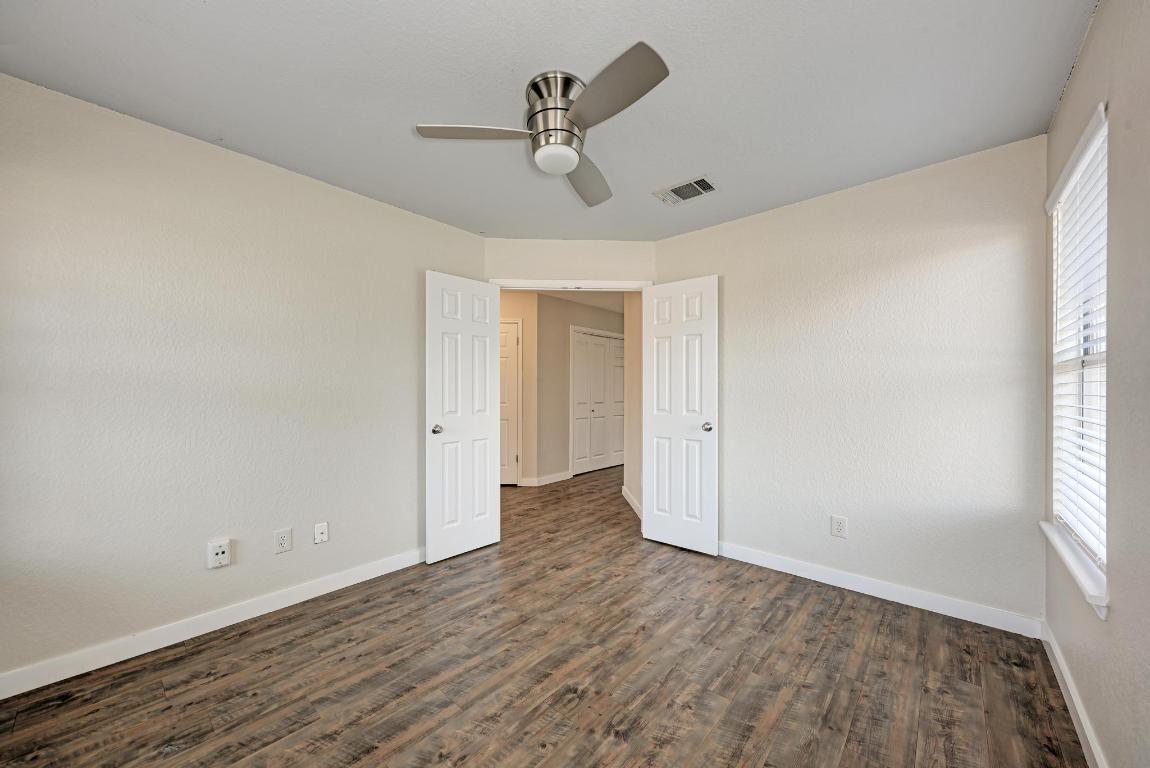 2317 Friarcreek Loop Round Rock, TX 78664 - Photo 18 of 36 a view of a room with wooden floor and ceiling fan