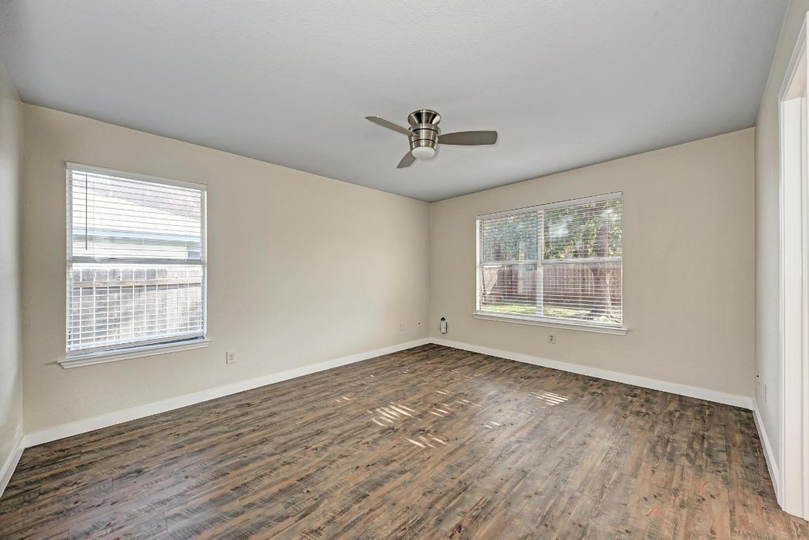 2317 Friarcreek Loop Round Rock, TX 78664 - Photo 19 of 36 a view of an empty room with wooden floor and a window