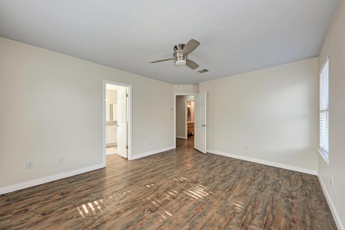 2317 Friarcreek Loop Round Rock, TX 78664 - Photo 20 of 36 a view of an empty room with wooden floor and a window