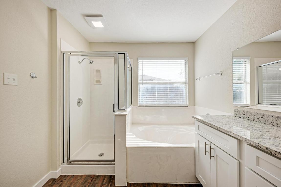 2317 Friarcreek Loop Round Rock, TX 78664 - Photo 22 of 36 a bathroom with a granite countertop sink and a bathtub