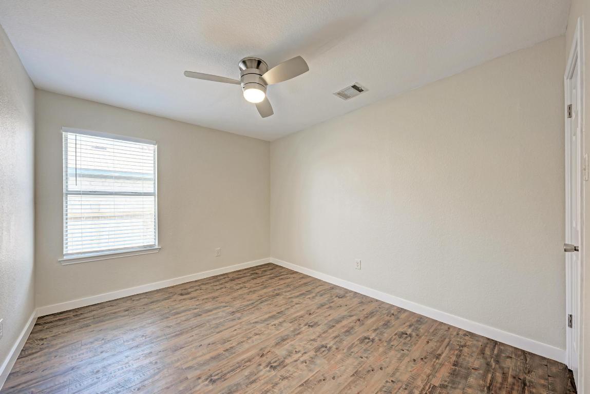 2317 Friarcreek Loop Round Rock, TX 78664 - Photo 24 of 36 an empty room with wooden floor and windows