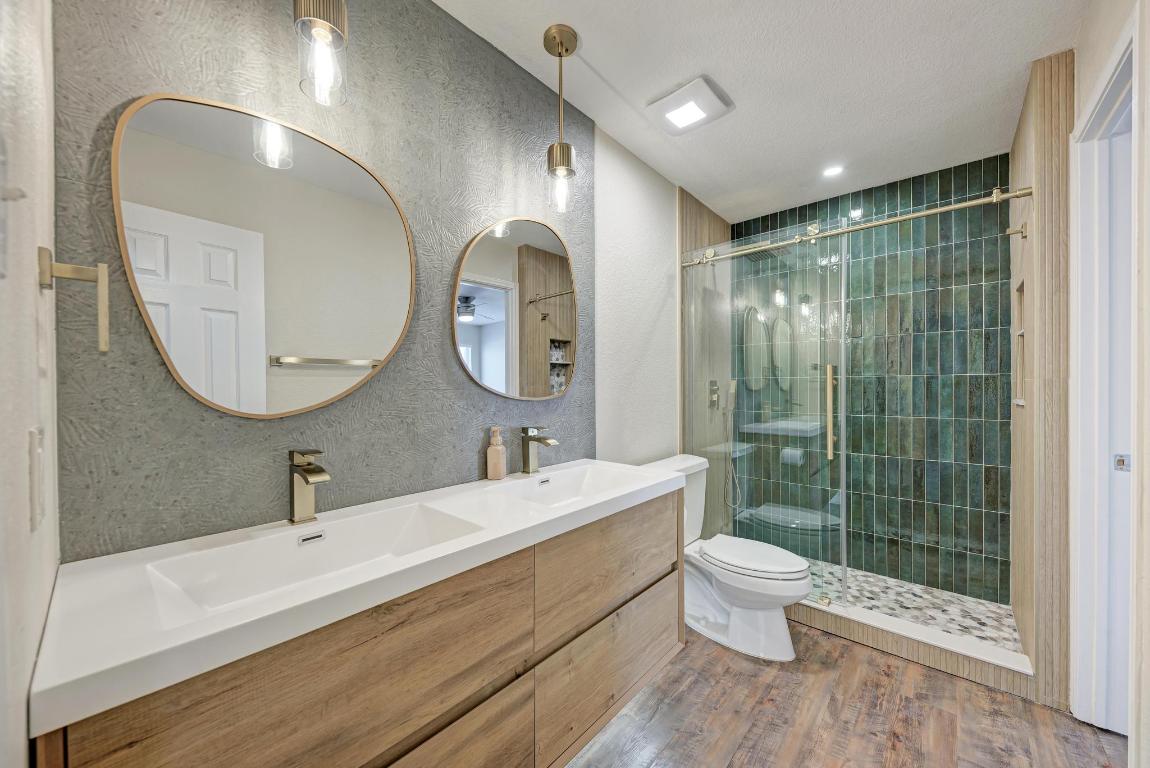 2317 Friarcreek Loop Round Rock, TX 78664 - Photo 26 of 36 a bathroom with a double vanity sink toilet mirror and shower