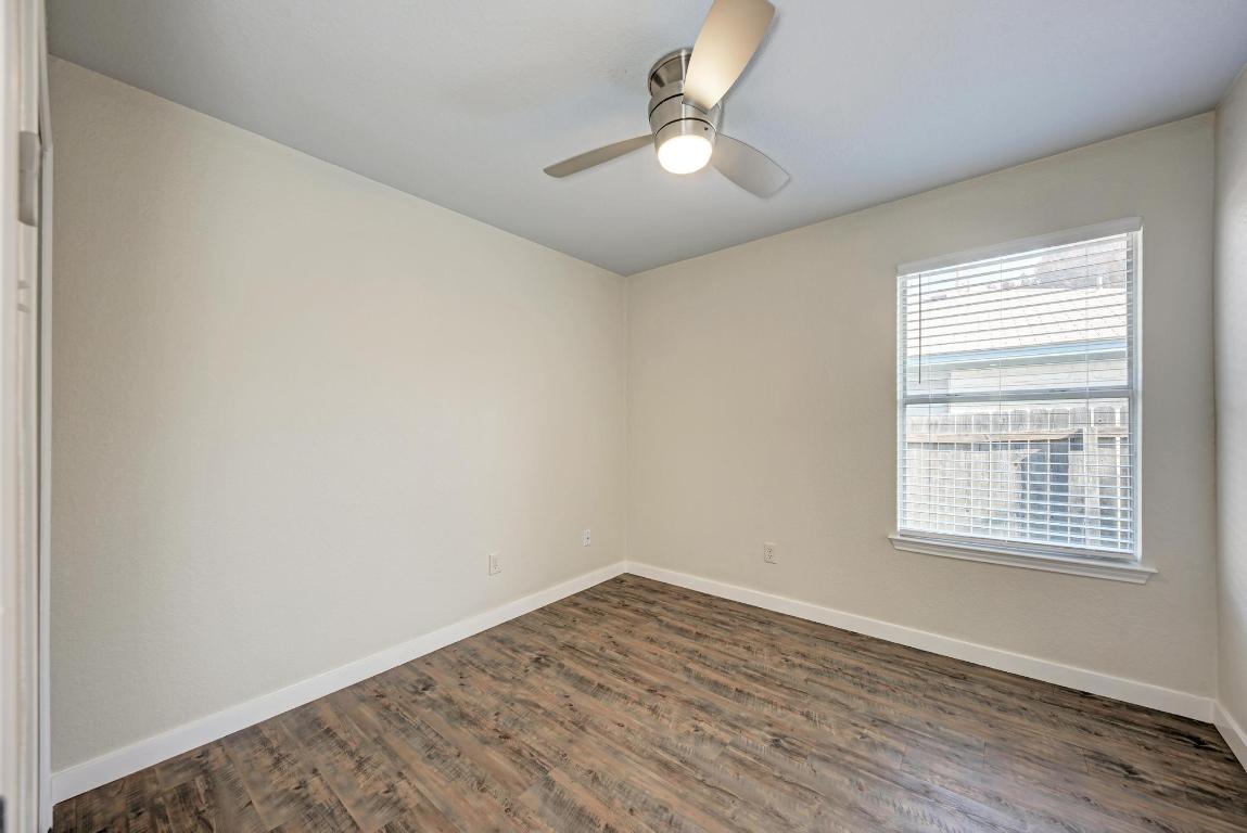 2317 Friarcreek Loop Round Rock, TX 78664 - Photo 27 of 36 wooden floor in an empty room with a window
