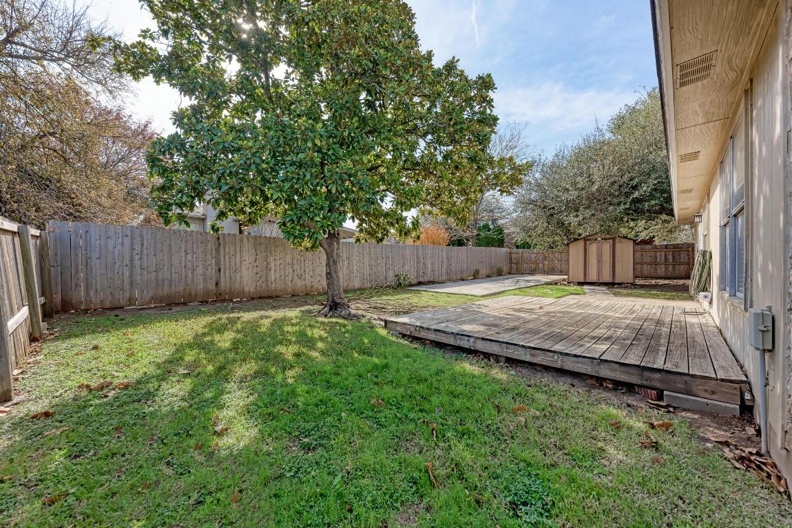 2317 Friarcreek Loop Round Rock, TX 78664 - Photo 30 of 36 a view of a backyard with a small cabin and wooden fence