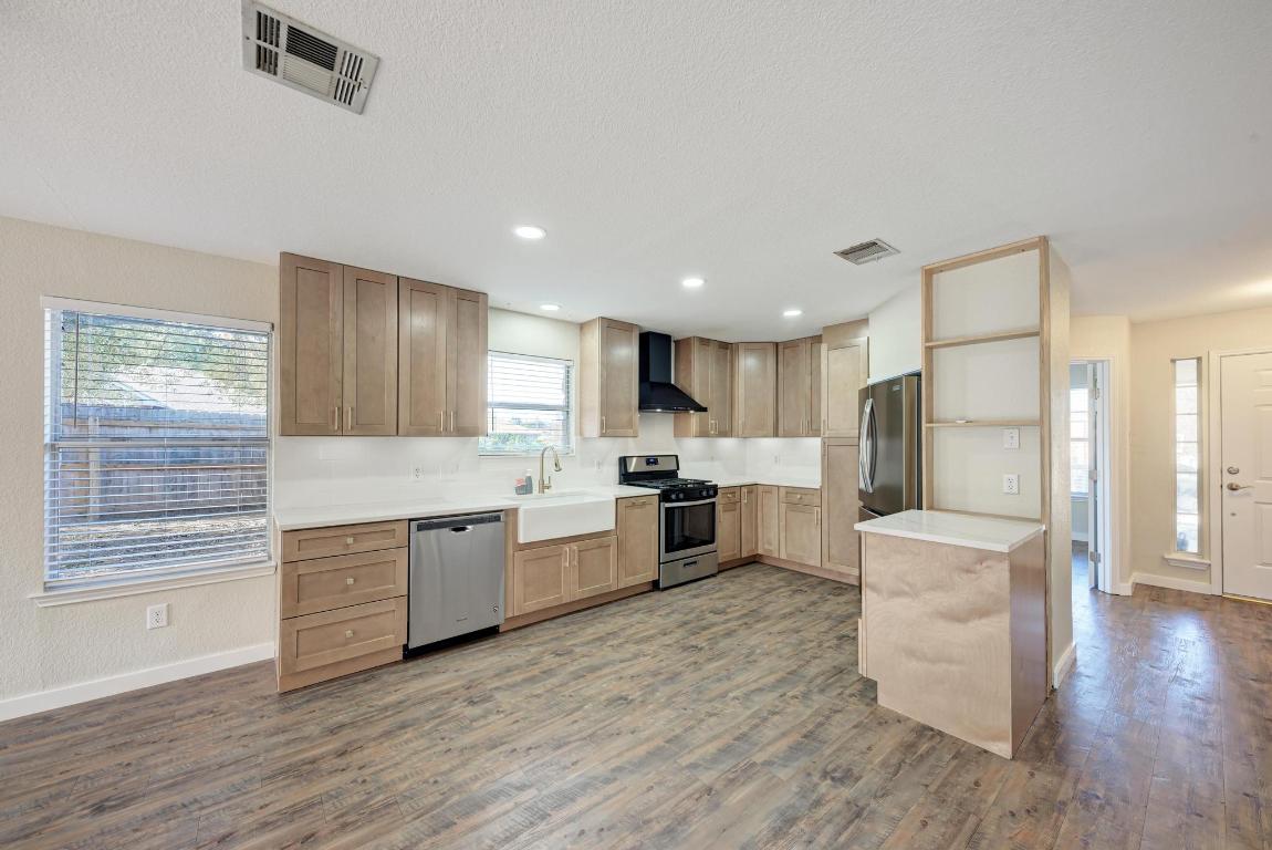 2317 Friarcreek Loop Round Rock, TX 78664 - Photo 8 of 36 a large kitchen with a large window and stainless steel appliances
