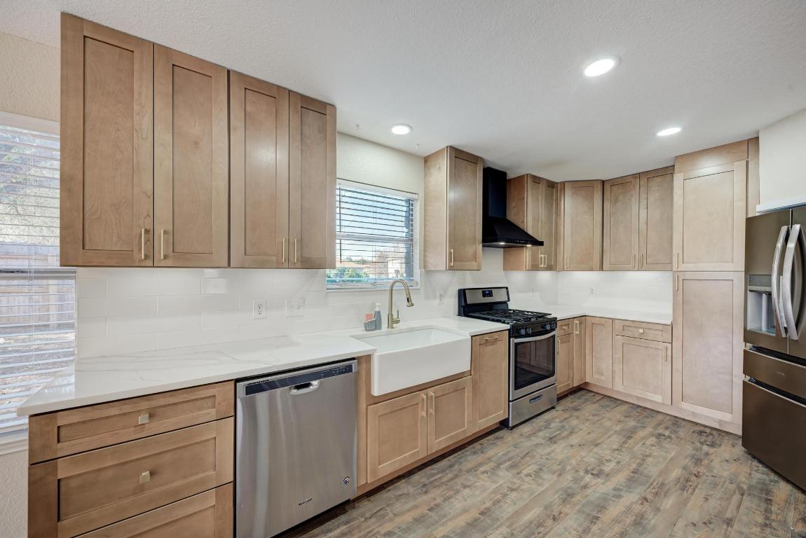 2317 Friarcreek Loop Round Rock, TX 78664 - Photo 10 of 36 a kitchen with a sink stainless steel appliances and cabinets
