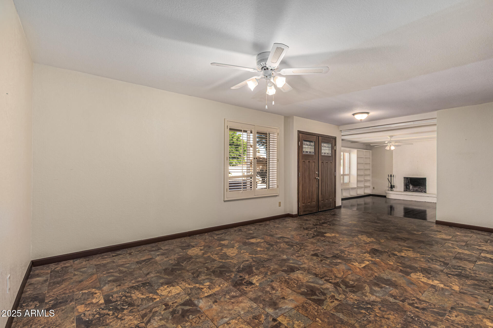 5109 East Kathleen Road Scottsdale, AZ 85254 - Photo 23 of 54 an empty room with chandelier fan and windows