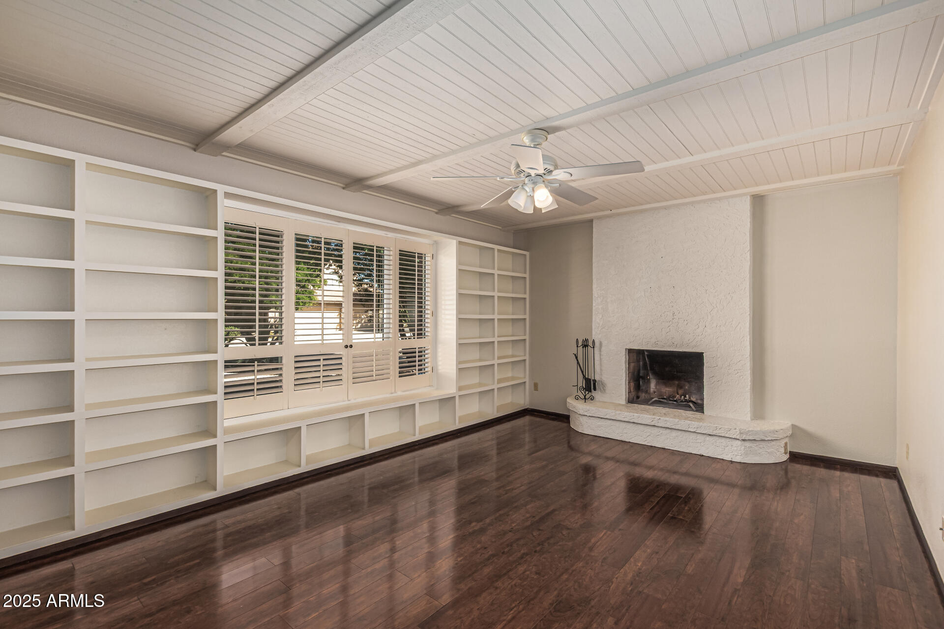 5109 East Kathleen Road Scottsdale, AZ 85254 - Photo 25 of 54 an empty room with wooden floor fire place and windows