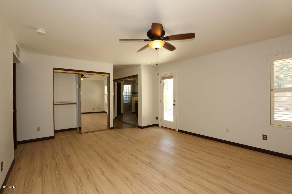 5109 East Kathleen Road Scottsdale, AZ 85254 - Photo 3 of 54 a view of empty room with wooden floor and fan