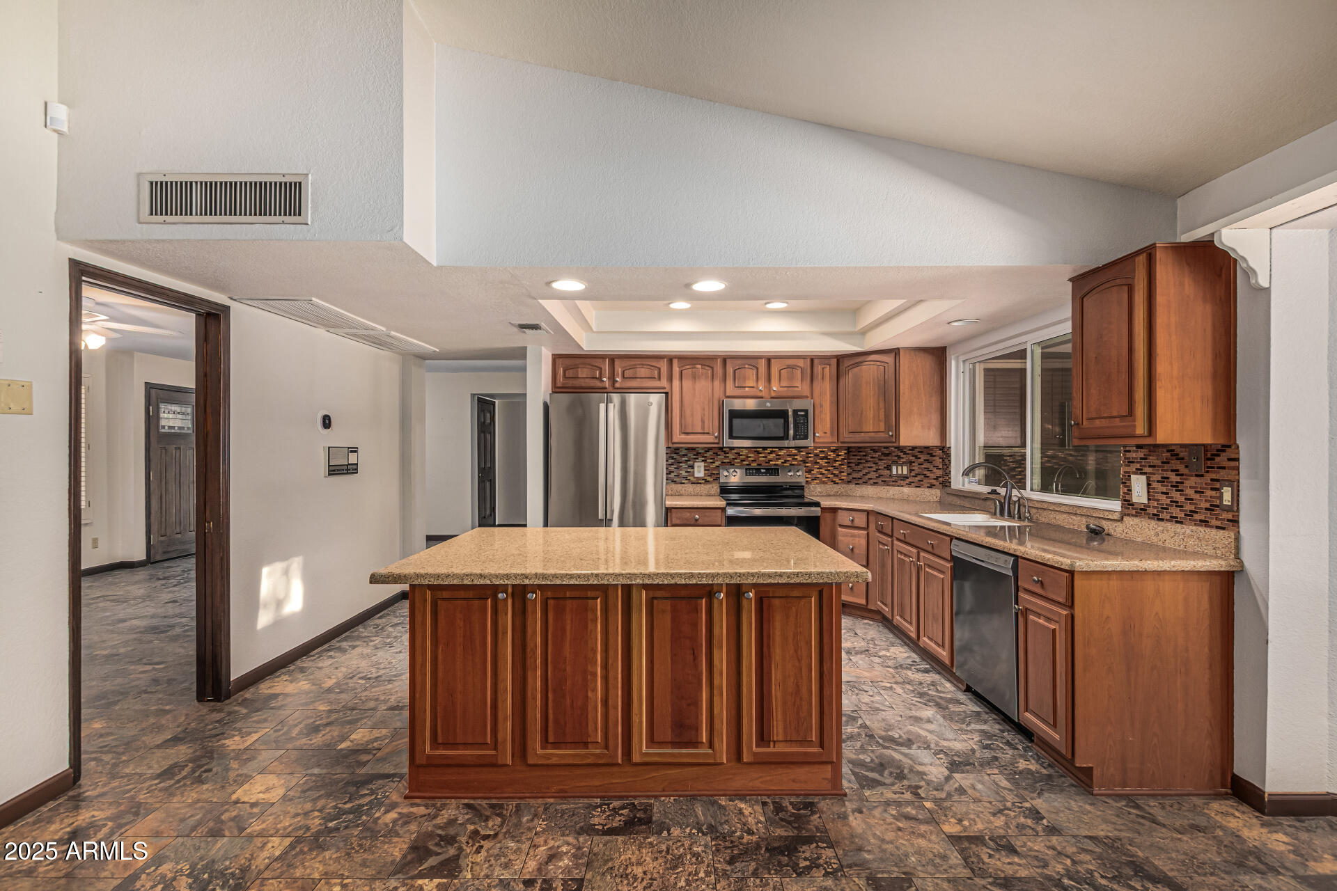 5109 East Kathleen Road Scottsdale, AZ 85254 - Photo 31 of 54 a kitchen with stainless steel appliances granite countertop a refrigerator a stove and a sink
