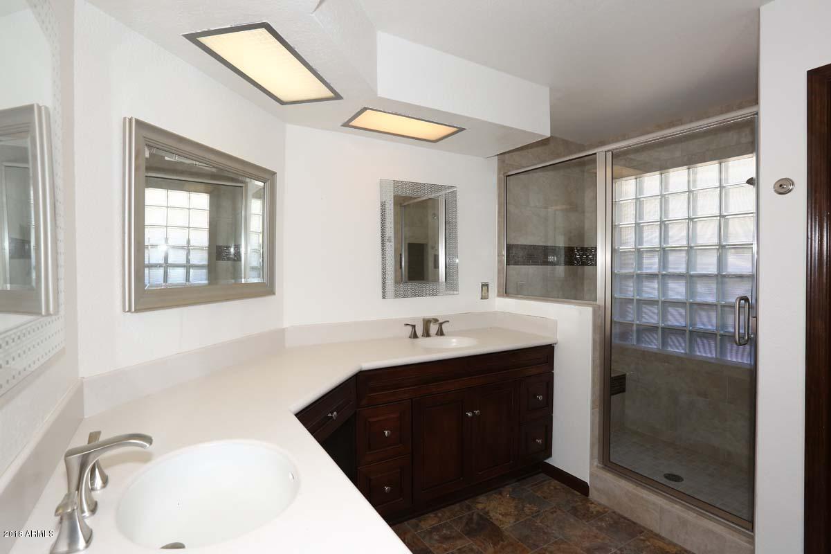 5109 East Kathleen Road Scottsdale, AZ 85254 - Photo 4 of 54 a bathroom with a sink and a mirror
