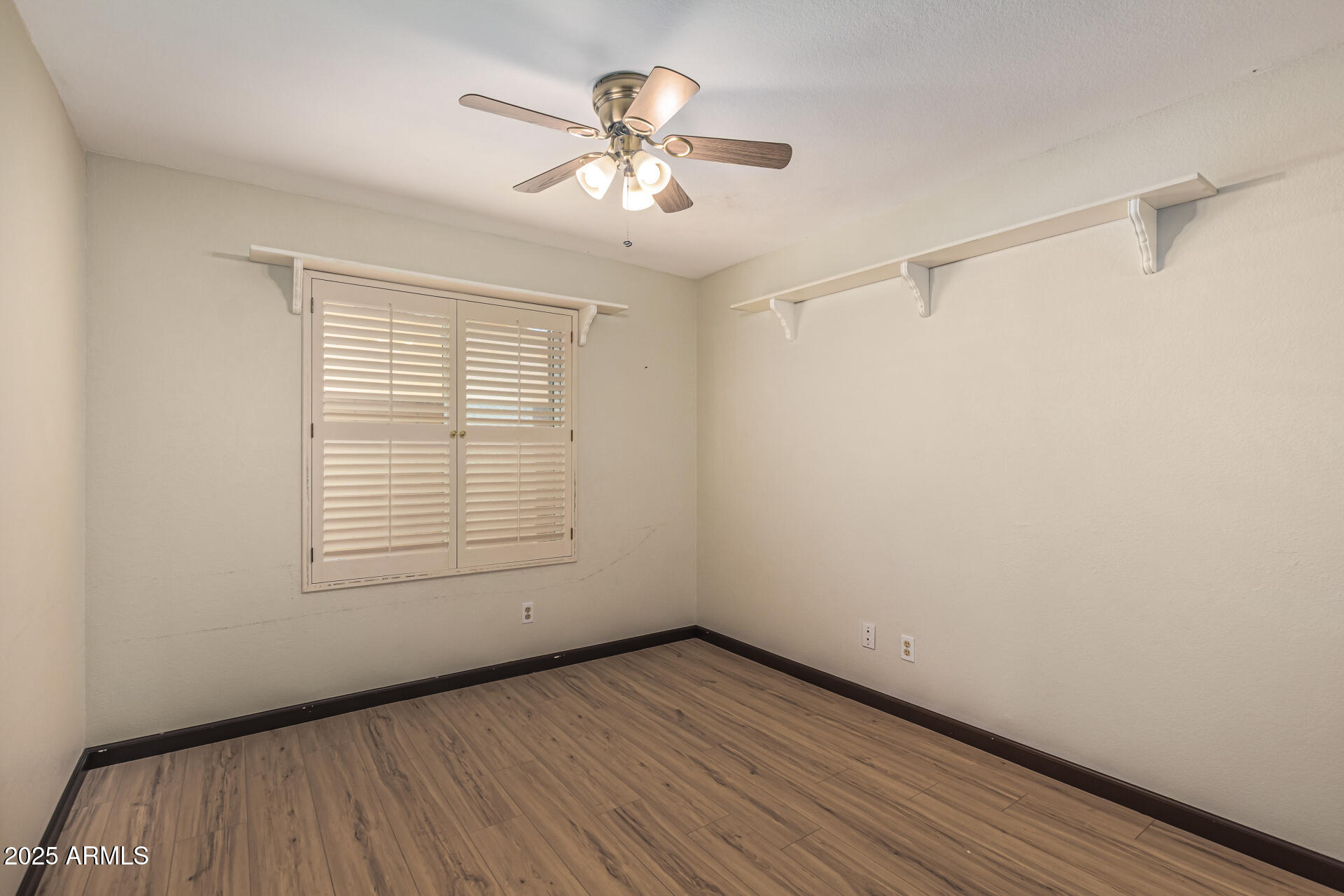 5109 East Kathleen Road Scottsdale, AZ 85254 - Photo 42 of 54 wooden floor in an empty room with a window