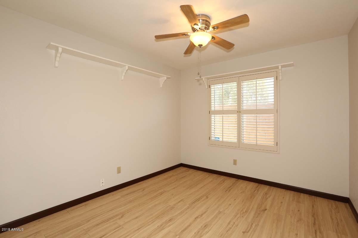 5109 East Kathleen Road Scottsdale, AZ 85254 - Photo 5 of 54 an empty room with a window and a fan