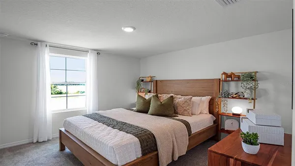 a bedroom with a bed and window