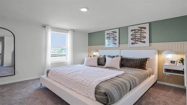 a bedroom with a bed and a night stand