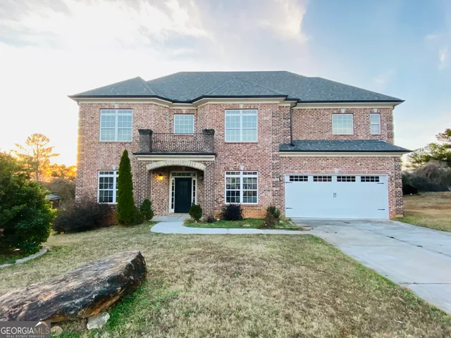 a front view of a house with yard and garage
