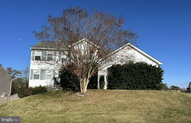 a view of a house with a snow in the yard