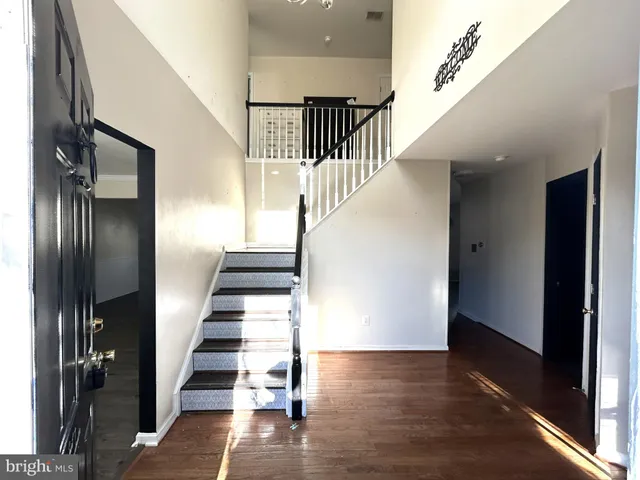 a view of entryway and hall with wooden floor