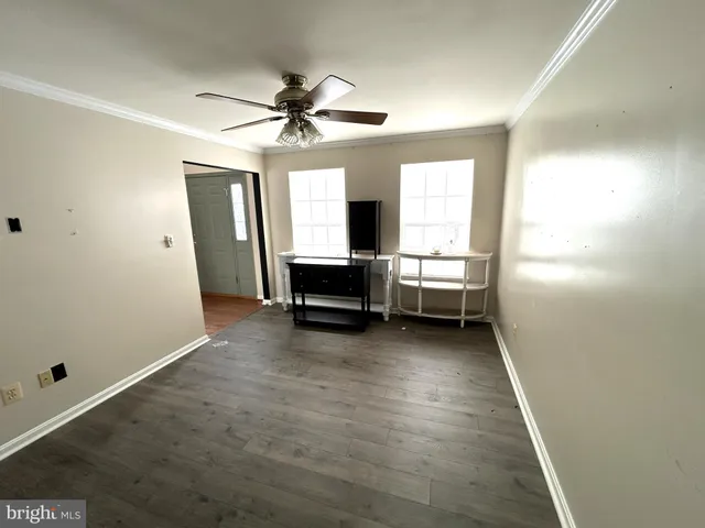 a view of room with window and a ceiling fan