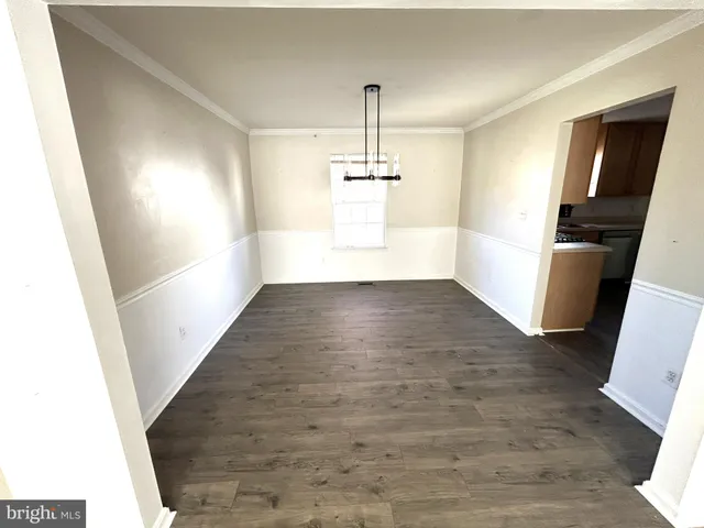 a view of a room with wooden floor and staircase