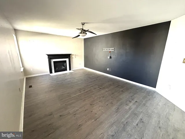 a view of empty room with a fireplace