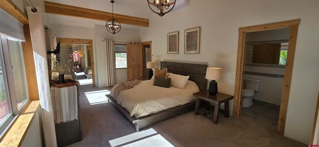 a bedroom with a bed and a mirror