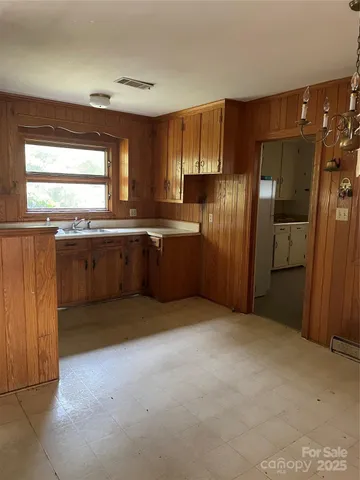 a view of a kitchen with a sink and dishwasher a refrigerator