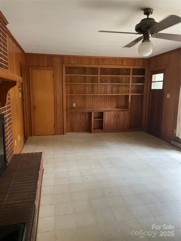 a view of an empty room with a fireplace
