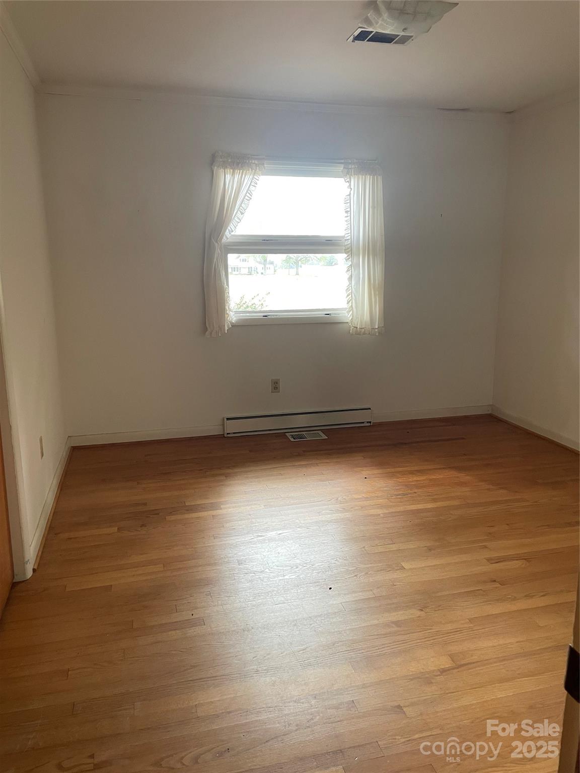 1450 Mt Tabor Church Road Cleveland, NC 27013 - Photo 9 of 14 an empty room with wooden floor and windows