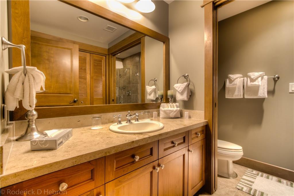 280 Trailhead Drive, Unit 3043 Keystone, CO 80435 - Photo 11 of 24 a bathroom with a granite countertop sink a toilet and a mirror