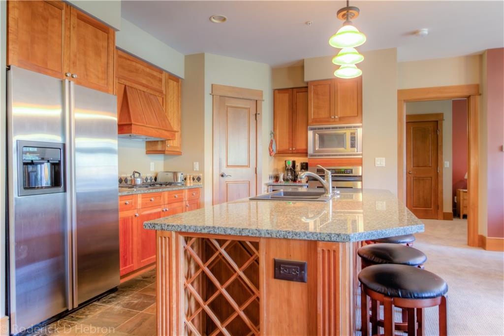 280 Trailhead Drive, Unit 3043 Keystone, CO 80435 - Photo 7 of 24 a kitchen with stainless steel appliances granite countertop a sink a stove and a refrigerator