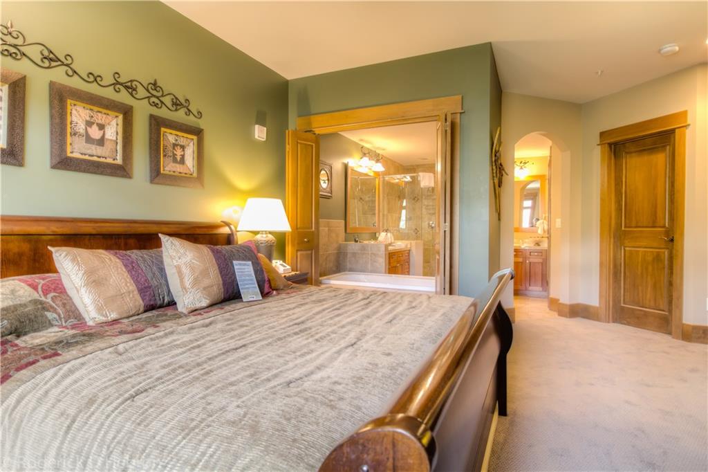 280 Trailhead Drive, Unit 3043 Keystone, CO 80435 - Photo 8 of 24 a spacious bedroom with a bed and a chandelier