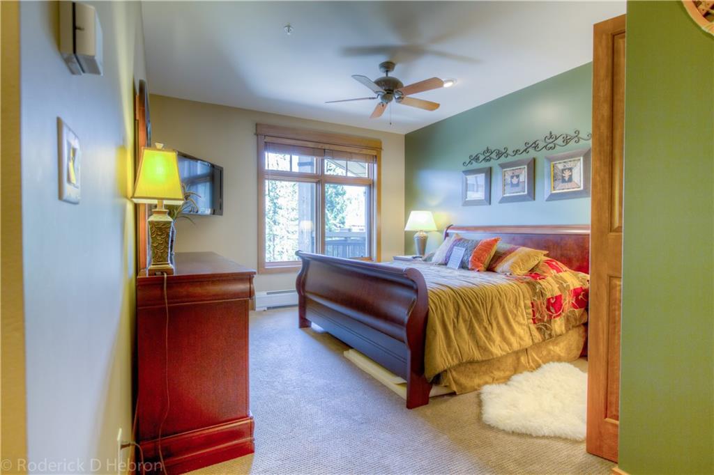 280 Trailhead Drive, Unit 3043 Keystone, CO 80435 - Photo 9 of 24 a bedroom with a bed and wooden floor