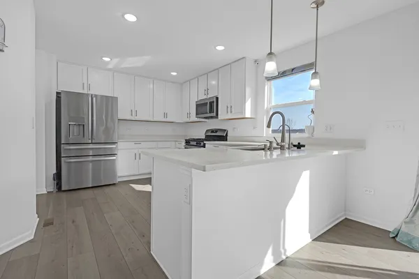 a kitchen with refrigerator cabinets and a sink