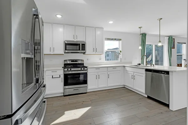 a kitchen with a sink stove and refrigerator