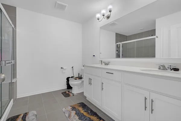 a bathroom with double vanity sink a mirror and vanity