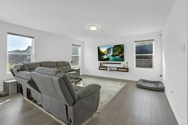 a living room with furniture window and flat screen tv