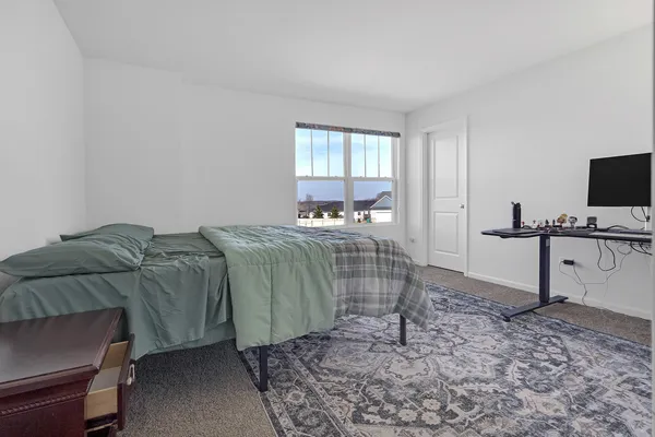 a bedroom with a bed and a television