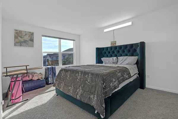a bedroom with a bed and window