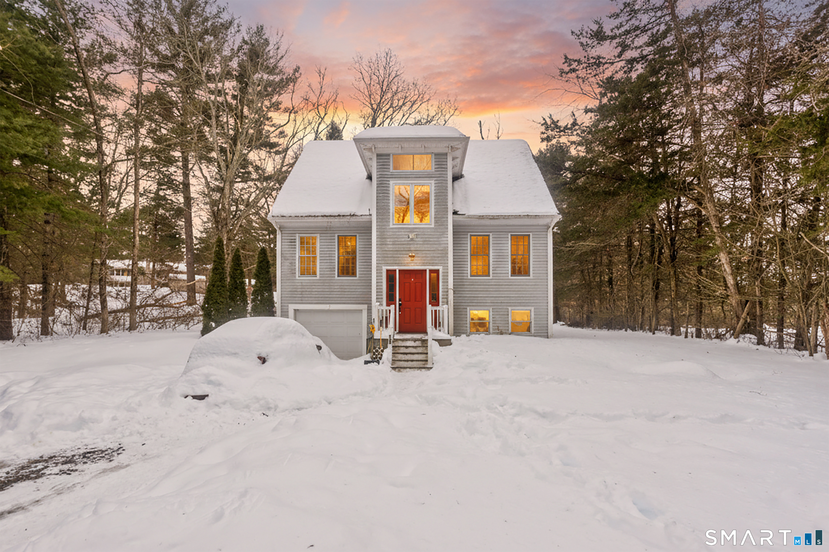 a view of a house with a snow in the yard