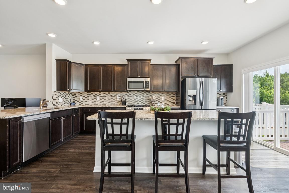 16 Naples Lane Mount Laurel, NJ 08054 - Photo 11 of 30 a kitchen with stainless steel appliances kitchen island granite countertop a table chairs sink and cabinets