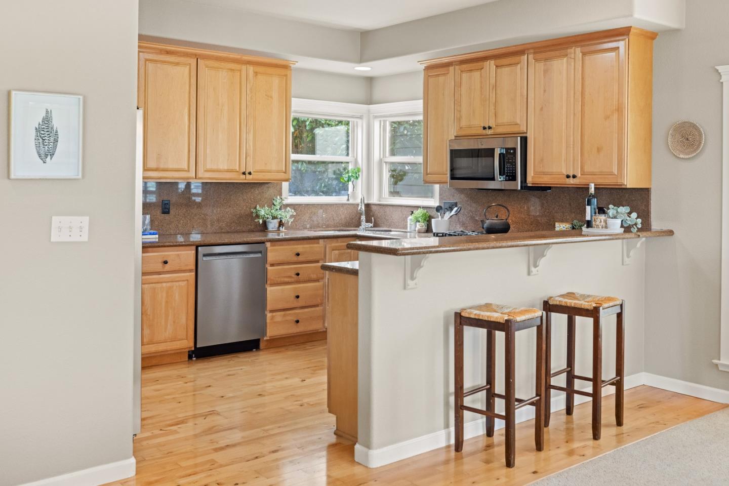 2549 Colonial Circle Watsonville, CA 95076 - Photo 13 of 54 a kitchen with stainless steel appliances granite countertop a stove top oven a sink a dining table and chairs