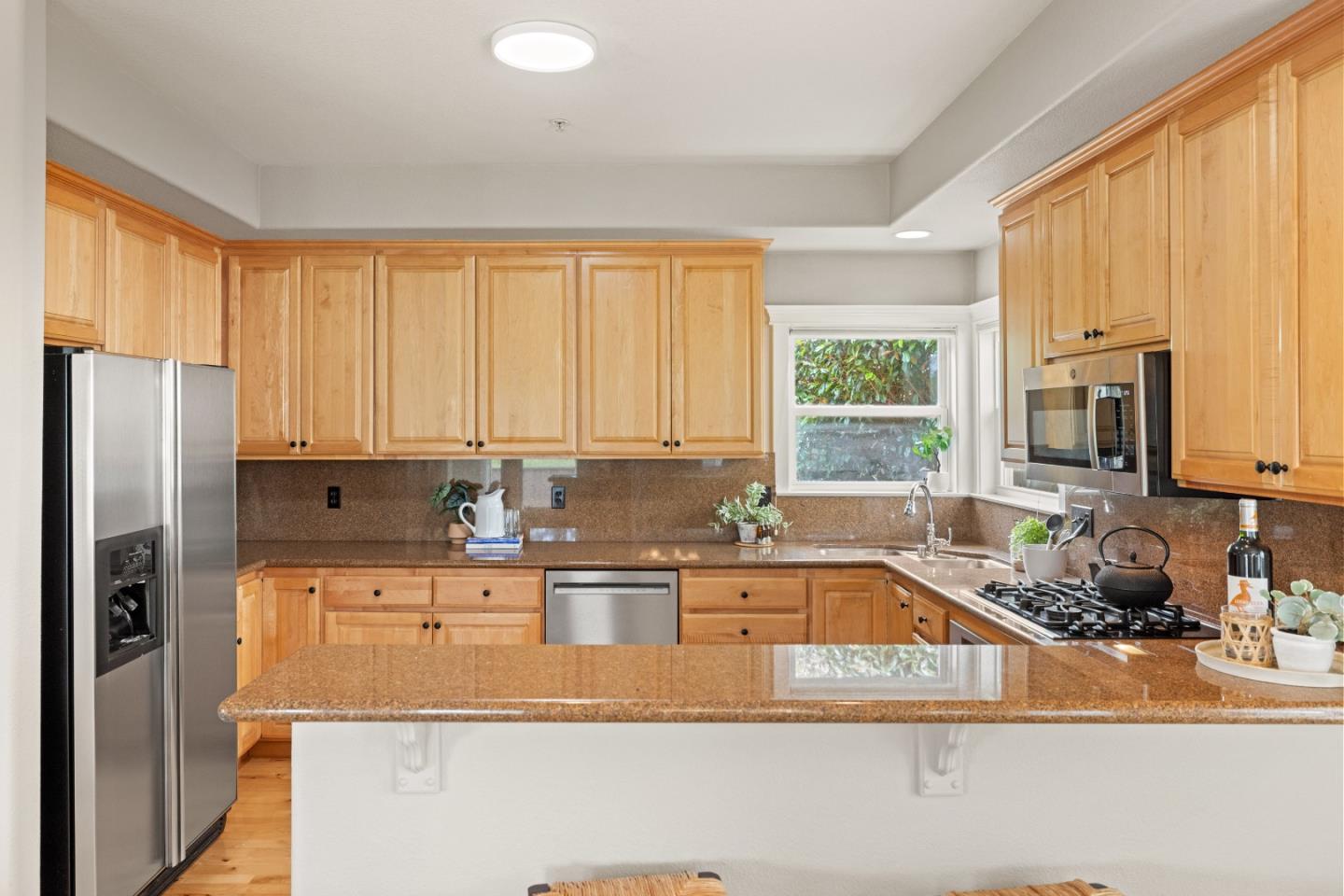 2549 Colonial Circle Watsonville, CA 95076 - Photo 14 of 54 a kitchen with stainless steel appliances granite countertop a sink a refrigerator and a granite counter tops with a large window