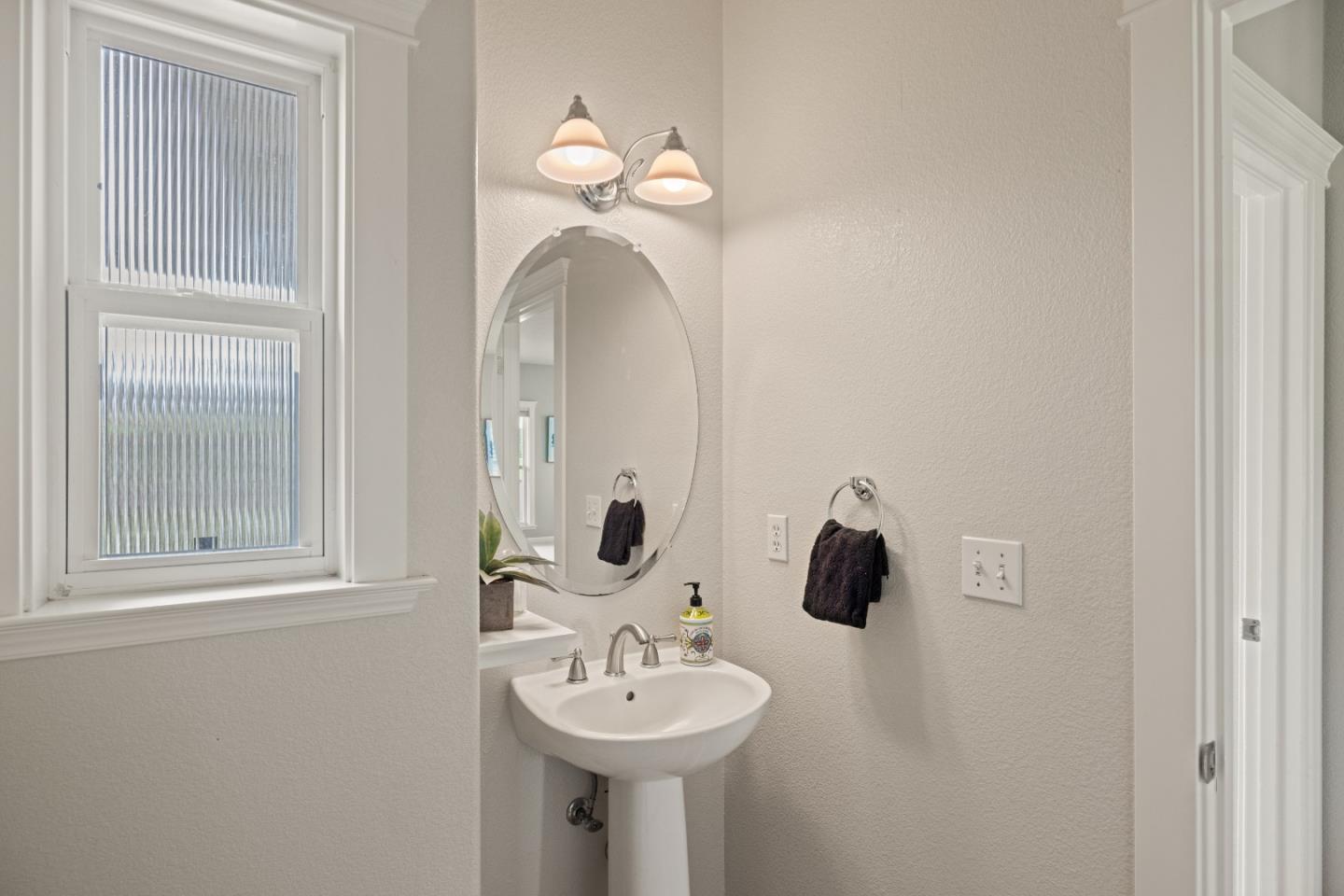 2549 Colonial Circle Watsonville, CA 95076 - Photo 40 of 54 a bathroom with a sink and a mirror