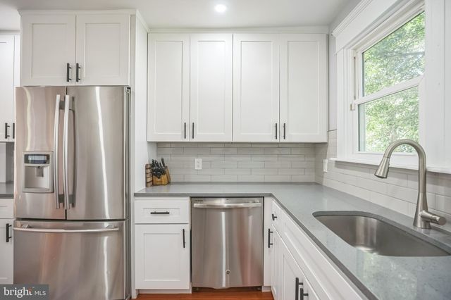 a kitchen with appliances cabinets and a sink